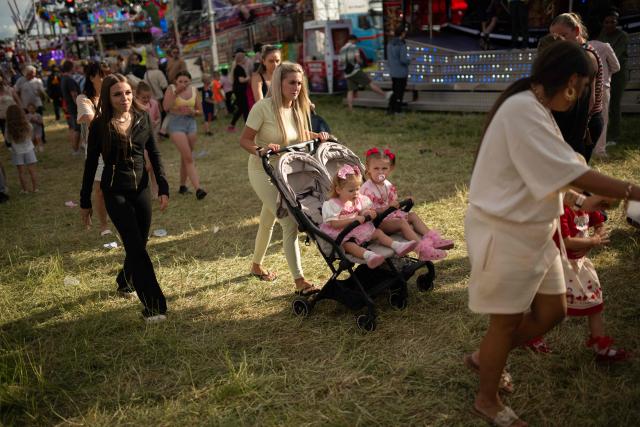 Members of the public attend The Hoppings fun fair, believed to be one of the largest travelling funfairs in Europe, in Newcastle upon Tyne, north east England on June 20, 2026. The fun fair, which originally began as a Temperance Fair in 1882, comprises of over 400 attractions set up on the city's Town Moor. The fair runs until June 28, 2026 and is expected to attract around 500,000 people. (Photo by Oli SCARFF / AFP)
