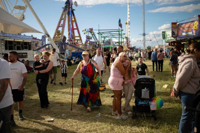 Members of the public attend The Hoppings fun fair, believed to be one of the largest travelling funfairs in Europe, in Newcastle upon Tyne, north east England on June 20, 2026. The fun fair, which originally began as a Temperance Fair in 1882, comprises of over 400 attractions set up on the city's Town Moor. The fair runs until June 28, 2026 and is expected to attract around 500,000 people. (Photo by Oli SCARFF / AFP)