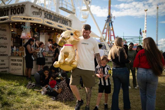 Members of the public attend The Hoppings fun fair, believed to be one of the largest travelling funfairs in Europe, in Newcastle upon Tyne, north east England on June 20, 2026. The fun fair, which originally began as a Temperance Fair in 1882, comprises of over 400 attractions set up on the city's Town Moor. The fair runs until June 28, 2026 and is expected to attract around 500,000 people. (Photo by Oli SCARFF / AFP)