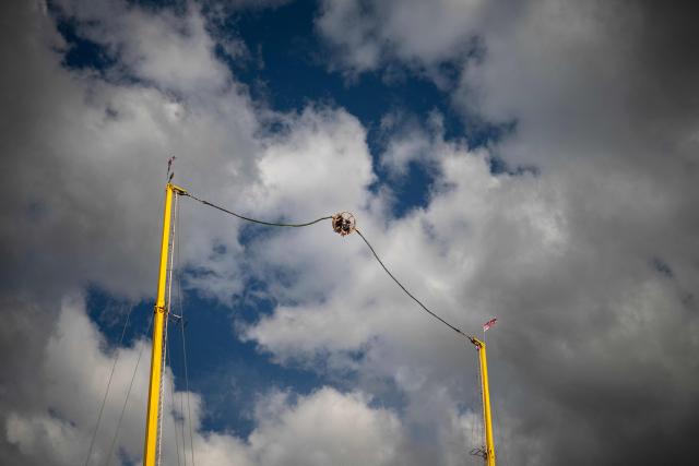 Customers are launched high into the air on a ride at The Hoppings fun fair, believed to be one of the largest travelling funfairs in Europe, in Newcastle upon Tyne, north east England on June 20, 2026. The fun fair, which originally began as a Temperance Fair in 1882, comprises of over 400 attractions set up on the city's Town Moor. The fair runs until June 28, 2026 and is expected to attract around 500,000 people. (Photo by Oli SCARFF / AFP)