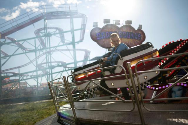 Members of the public attend The Hoppings fun fair, believed to be one of the largest travelling funfairs in Europe, in Newcastle upon Tyne, north east England on June 20, 2026. The fun fair, which originally began as a Temperance Fair in 1882, comprises of over 400 attractions set up on the city's Town Moor. The fair runs until June 28, 2026 and is expected to attract around 500,000 people. (Photo by Oli SCARFF / AFP)