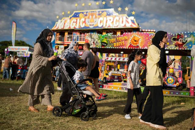 Members of the public attend The Hoppings fun fair, believed to be one of the largest travelling funfairs in Europe, in Newcastle upon Tyne, north east England on June 20, 2026. The fun fair, which originally began as a Temperance Fair in 1882, comprises of over 400 attractions set up on the city's Town Moor. The fair runs until June 28, 2026 and is expected to attract around 500,000 people. (Photo by Oli SCARFF / AFP)