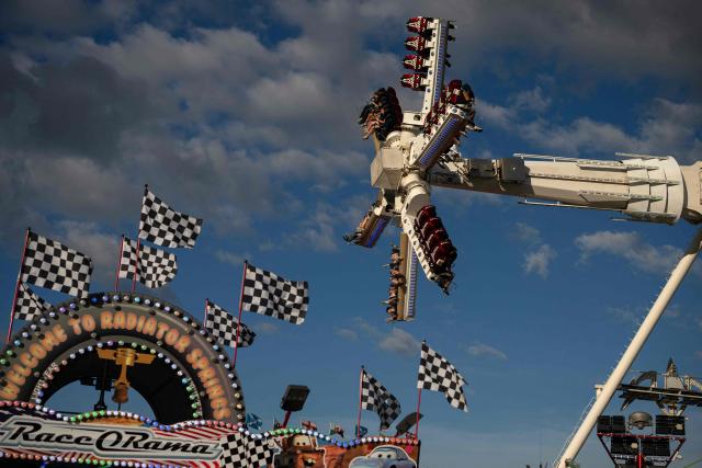 Members of the public attend The Hoppings fun fair, believed to be one of the largest travelling funfairs in Europe, in Newcastle upon Tyne, north east England on June 20, 2026. The fun fair, which originally began as a Temperance Fair in 1882, comprises of over 400 attractions set up on the city's Town Moor. The fair runs until June 28, 2026 and is expected to attract around 500,000 people. (Photo by Oli SCARFF / AFP)