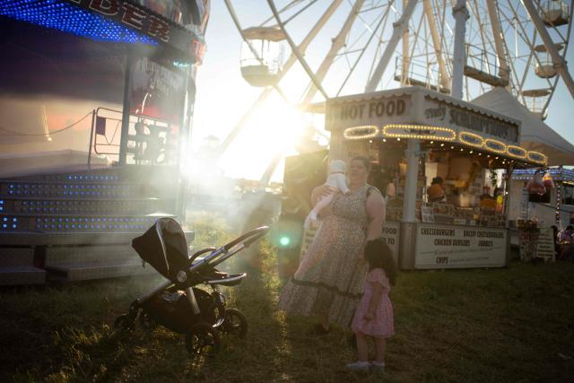 Members of the public attend The Hoppings fun fair, believed to be one of the largest travelling funfairs in Europe, in Newcastle upon Tyne, north east England on June 20, 2026. The fun fair, which originally began as a Temperance Fair in 1882, comprises of over 400 attractions set up on the city's Town Moor. The fair runs until June 28, 2026 and is expected to attract around 500,000 people. (Photo by Oli SCARFF / AFP)