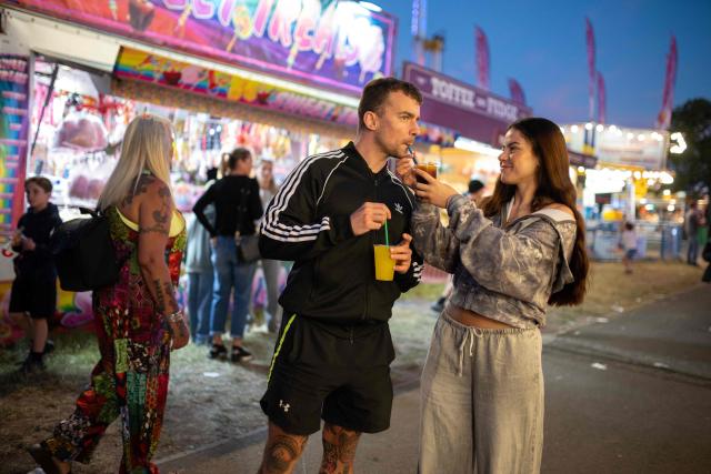 Members of the public attend The Hoppings fun fair, believed to be one of the largest travelling funfairs in Europe, in Newcastle upon Tyne, north east England on June 20, 2026. The fun fair, which originally began as a Temperance Fair in 1882, comprises of over 400 attractions set up on the city's Town Moor. The fair runs until June 28, 2026 and is expected to attract around 500,000 people. (Photo by Oli SCARFF / AFP)