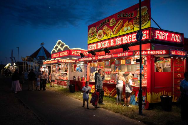 Members of the public attend The Hoppings fun fair, believed to be one of the largest travelling funfairs in Europe, in Newcastle upon Tyne, north east England on June 20, 2026. The fun fair, which originally began as a Temperance Fair in 1882, comprises of over 400 attractions set up on the city's Town Moor. The fair runs until June 28, 2026 and is expected to attract around 500,000 people. (Photo by Oli SCARFF / AFP)