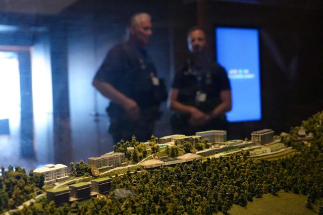 Police officers stand behind a model of the Burgenstock luxury hotel displayed in a case at the Burgenstock luxury hotel complex overlooking Lake Lucerne, Switzerland, on June 21, 2026, ahead of high-level talks aimed at advancing a deal to end the Middle East conflict. A new round of negotiations over the Middle East war was set to kick off on June 21, 2026 with Iranian negotiators arriving in the Swiss host city hours ahead of US Vice President JD Vance, even as Tehran said it was closing the Strait of Hormuz again over Israeli attacks in Lebanon. (Photo by Nathan Howard / POOL / AFP)