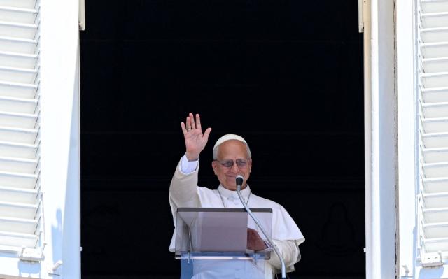 Pope Leo XIV blesses the crowd from a window of the apostolic palace overlooking St Peter's Square during the Angelus prayer in The Vatican on June 21, 2026. (Photo by TIZIANA FABI / AFP)