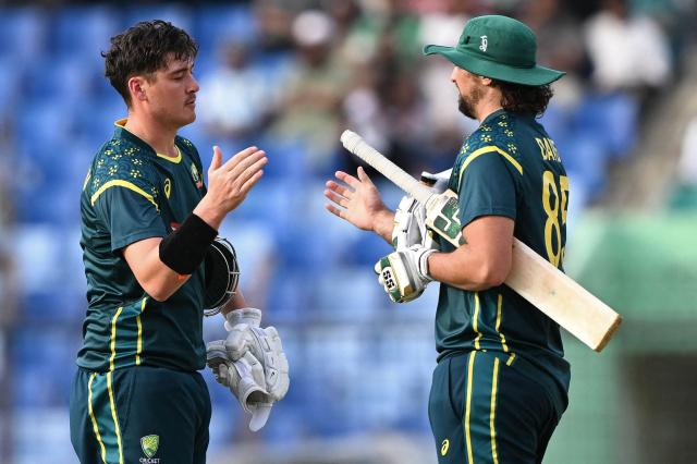 Australia's Matt Renshaw (L) and Tim David celebrate their team's win against Bangladesh at the end of their third Twenty20 (T20) international cricket match in the Bir Sreshtho Flight Lieutenant Matiur Rahman Stadium of Chattogram on June 21, 2026. (Photo by AFP)