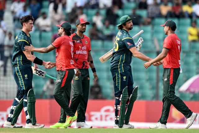 Australia's Matt Renshaw (L) and Tim David (2R) are congratulated by Bangladesh's players for their team's win at the end of the third Twenty20 (T20) international cricket match between Bangladesh and Australia in the Bir Sreshtho Flight Lieutenant Matiur Rahman Stadium of Chattogram on June 21, 2026. (Photo by AFP)
