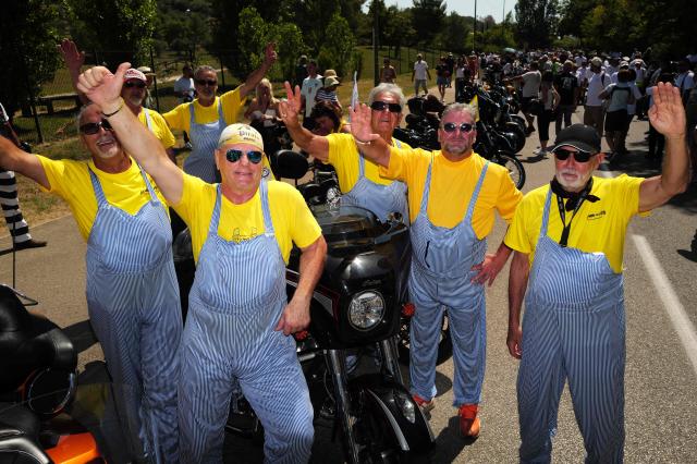 Attendees dressed up as Coluche pose as they take part in a "Run Coluche" biker gathering as part of a tribute to French comedian and actor Coluche 40 years after his death, in Opio, southeastern France, on June 21, 2026. (Photo by Valery HACHE / AFP)