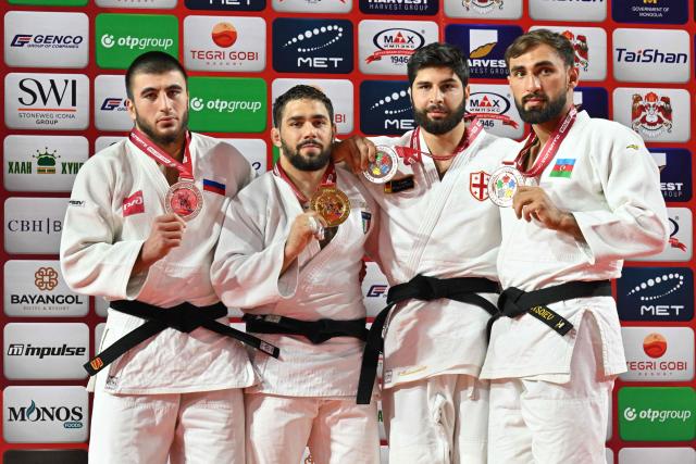 Gold medallist Gennaro Pirelli of Italy (2nd L), silver medallist Idar Bifov of Russia (L), bronze medallists Ilia Sulamanidze of Georgia (2nd R) and Zelym Kotsoiev of Azerbaijan pose for photos during the medal ceremony for the men's -100kg category at the Judo Ulaanbaatar Grand Slam 2026 in Ulaanbaatar on June 21, 2026. (Photo by ADEK BERRY / AFP)