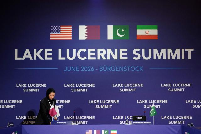A member of the Qatari delegation makes adjustments ahead of a quadrilateral meeting between the United States, Iran, Pakistan, and Qatar at the Burgenstock luxury hotel complex overlooking Lake Lucerne, Switzerland, on June 21, 2026, as part of high-level talks aimed at advancing a deal to end the Middle East conflict. A new round of negotiations over the Middle East war was set to kick off on June 21, 2026 with Iranian negotiators arriving in the Swiss host city hours ahead of US Vice President JD Vance, even as Tehran said it was closing the Strait of Hormuz again over Israeli attacks in Lebanon. (Photo by Nathan Howard / POOL / AFP)