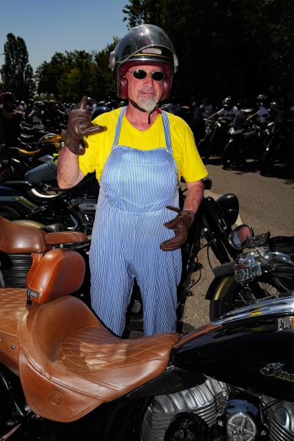 An attendee gestures as he poses dressed up as Coluche during a "Run Coluche" biker gathering as part of a tribute to French comedian and actor Coluche 40 years after his death, in Opio, southeastern France, on June 21, 2026. (Photo by Valery HACHE / AFP)