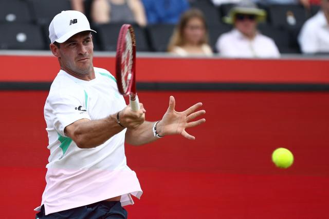 US player Tommy Paul returns to Argentina's Francisco Cerundolo during the men's singles final tennis match on day six of the ATP HSBC Championships at Queen's Club in west London on June 21, 2026. (Photo by Henry NICHOLLS / AFP)