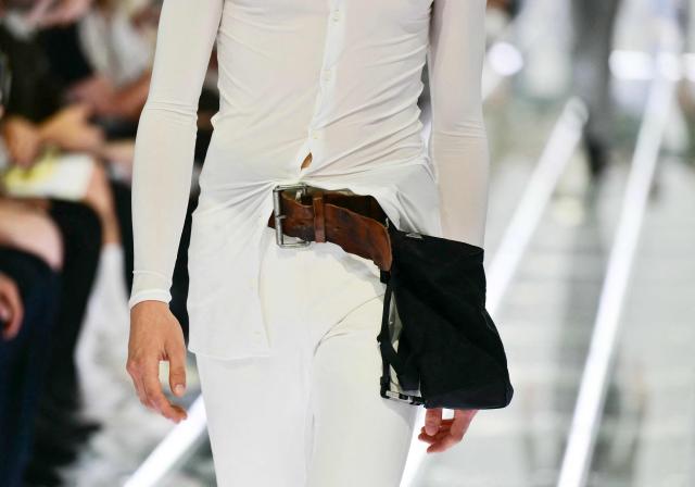 A model presents a belt and a bag during the Prada collection show as part of Spring/Summer 2027 men's collection at Milan Fashion Week, on June 21, 2026. (Photo by Stefano RELLANDINI / AFP)