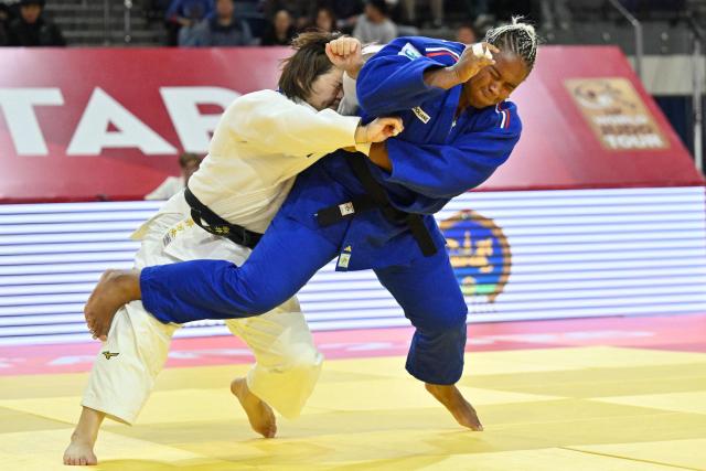 Mao Arai of Japan (in white) and Romane Dicko of France (in blue) compete in the final of the women's +78kg category at the Judo Ulaanbaatar Grand Slam 2026 in Ulaanbaatar on June 21, 2026. (Photo by ADEK BERRY / AFP)