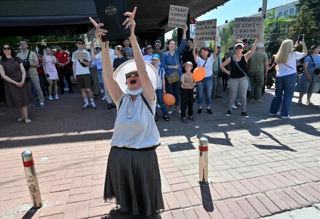 An elderly woman bandishes a Bible during a counter-rally against the Kyiv Pride March 2026 and in defense of "traditional values" in Kyiv on June 21, 2026, amid Russian invasion in Ukraine. (Photo by Sergei SUPINSKY / AFP)