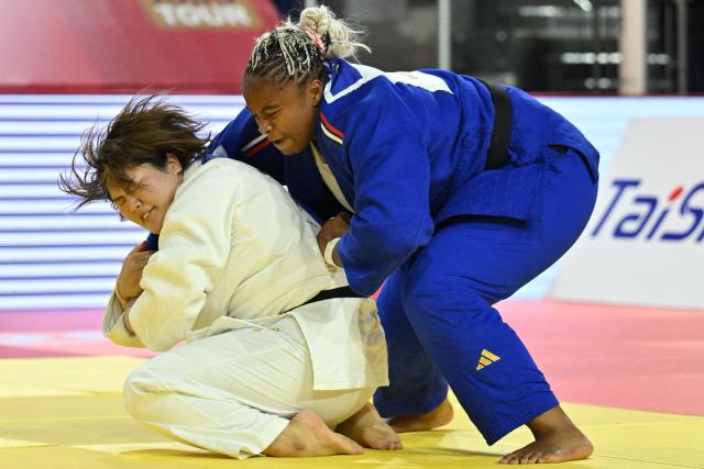 Mao Arai of Japan (in white) and Romane Dicko of France (in blue) compete in the final of the women's +78kg category at the Judo Ulaanbaatar Grand Slam 2026 in Ulaanbaatar on June 21, 2026. (Photo by ADEK BERRY / AFP)
