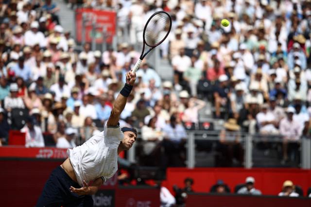 Argentina's Francisco Cerundolo serves to US player Tommy Paul during the men's singles final tennis match on day six of the ATP HSBC Championships at Queen's Club in west London on June 21, 2026. (Photo by Henry NICHOLLS / AFP)