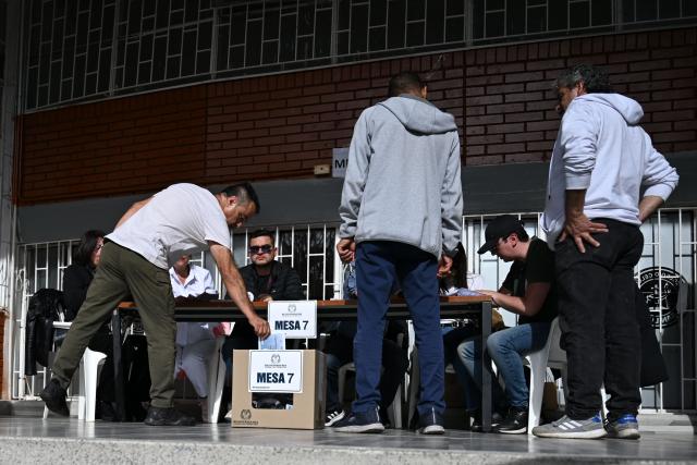 A man votes at a polling station during the presidential election runoff, in Bogota on June 21, 2026. Colombians head to the polls to pick a new president between a hard-right White House-backed lawyer and a leftist senator that will decide the fate of the country's stumbling peace process and strained ties with Washington. (Photo by Raul ARBOLEDA / AFP)