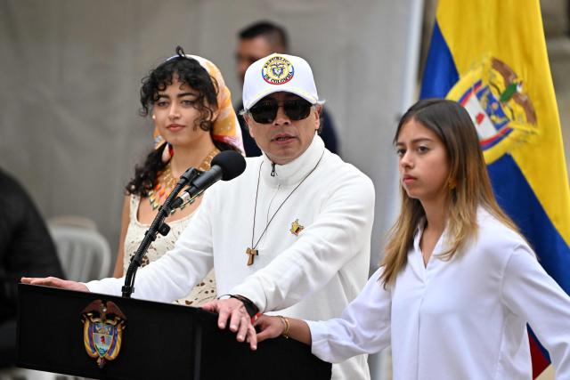 Colombia's President Gustavo Petro speaks next to his daughters Sofia (L) and Antonella at a polling station during the presidential election runoff, in Bogota on June 21, 2026. Colombians head to the polls to pick a new president between a hard-right White House-backed lawyer and a leftist senator that will decide the fate of the country's stumbling peace process and strained ties with Washington. (Photo by Luis ACOSTA / AFP)