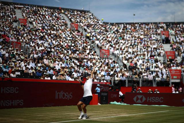 Argentina's Francisco Cerundolo serves to US player Tommy Paul during the men's singles final tennis match on day six of the ATP HSBC Championships at Queen's Club in west London on June 21, 2026. (Photo by Henry NICHOLLS / AFP)