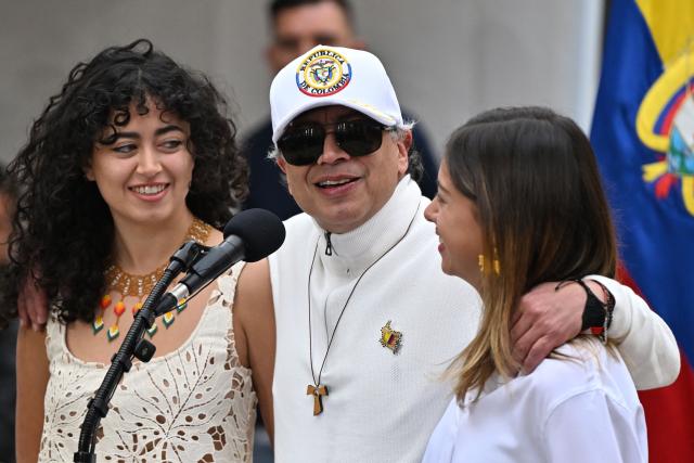 Colombia's President Gustavo Petro speaks next to his daughters Sofia (L) and Antonella at a polling station during the presidential election runoff, in Bogota on June 21, 2026. Colombians head to the polls to pick a new president between a hard-right White House-backed lawyer and a leftist senator that will decide the fate of the country's stumbling peace process and strained ties with Washington. (Photo by Luis ACOSTA / AFP)