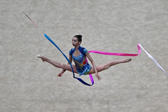 China's Wang Qi competes in the individual ribbon of the 2026 Rhythmic Gymnastics World Challenge Cup in Beijing on June 21, 2026. (Photo by Pedro PARDO / AFP)