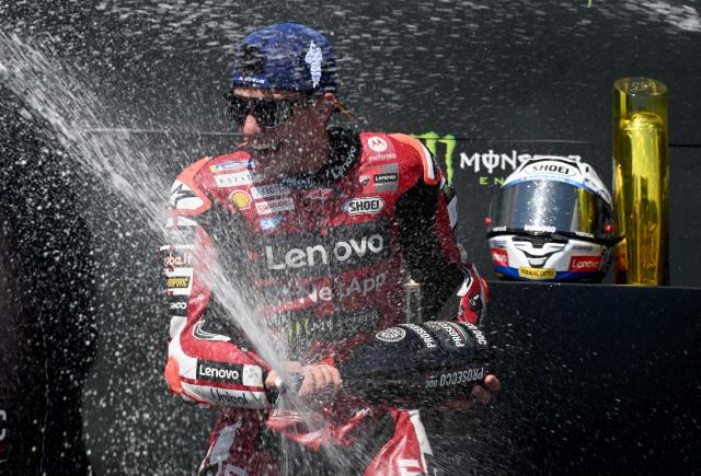 Team Ducati Lenovo Team's Marc Marquez celebrates on the podium with sparkling wine after winning the MotoGP Grand Prix of Czechia in Brno, Czech Republic, on June 21, 2026. (Photo by Michal Cizek / AFP)