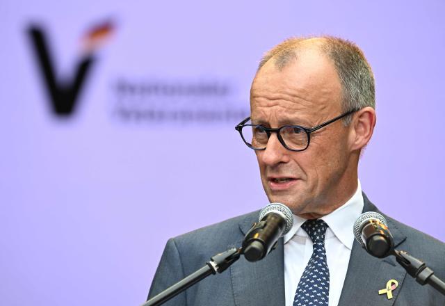 German Chancellor Friedrich Merz gives a speech during an event to mark the National Veterans' Day on June 21, 2026 in Berlin. The achievements of serving and former soldiers of the German armed forces (Bundeswehr) is honoured through events held across the country and a central celebration in Berlin. (Photo by RALF HIRSCHBERGER / AFP)
