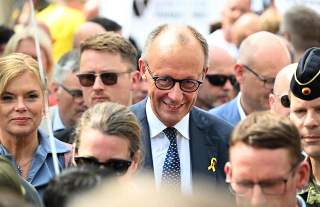 German Chancellor Friedrich Merz (C) and the President of the Bundestag (lower house of parliament) Julia Kloeckner (L) attend an event to mark the National Veterans' Day on June 21, 2026 in Berlin. The achievements of serving and former soldiers of the German armed forces (Bundeswehr) is honoured through events held across the country and a central celebration in Berlin. (Photo by RALF HIRSCHBERGER / AFP)