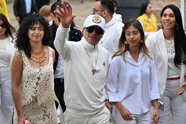 Colombia's President Gustavo Petro waves next to his daughters Sofia (L) and Antonella at a polling station during the presidential election runoff, in Bogota on June 21, 2026. Colombians head to the polls to pick a new president between a hard-right White House-backed lawyer and a leftist senator that will decide the fate of the country's stumbling peace process and strained ties with Washington. (Photo by Luis ACOSTA / AFP)