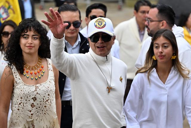Colombia's President Gustavo Petro waves next to his daughters Sofia (L) and Antonella at a polling station during the presidential election runoff, in Bogota on June 21, 2026. Colombians head to the polls to pick a new president between a hard-right White House-backed lawyer and a leftist senator that will decide the fate of the country's stumbling peace process and strained ties with Washington. (Photo by Luis ACOSTA / AFP)