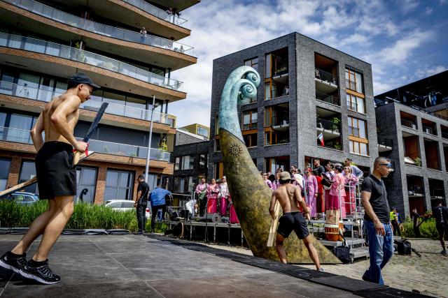 Artists perform ahead of the unveiling of a national monument at the Lloydkade for Moluccans during the commemoration of the Moluccan community that arrived there 75 years ago, in Rotterdam on June 21, 2026. In 1946, the first Moluccan men came to the Netherlands for training with the Royal Netherlands Navy, after which they served in active service in Amsterdam, as well as in Indonesia and other parts of the Kingdom. (Photo by Robin Utrecht / ANP / AFP) / Netherlands OUT