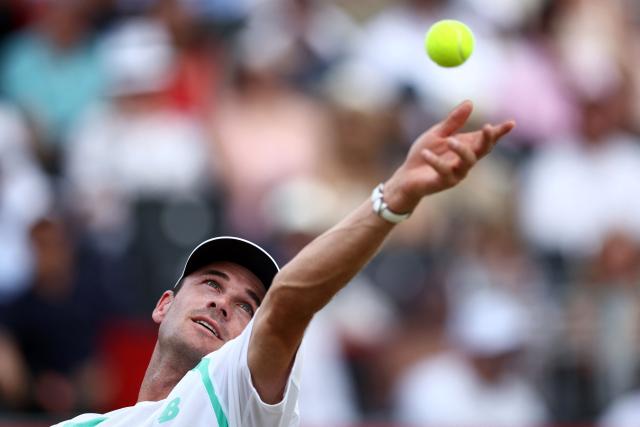US player Tommy Paul serves to Argentina's Francisco Cerundolo during the men's singles final tennis match on day six of the ATP HSBC Championships at Queen's Club in west London on June 21, 2026. (Photo by Henry NICHOLLS / AFP)