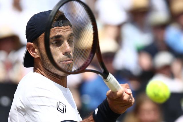 Argentina's Francisco Cerundolo returns to US player Tommy Paul during the men's singles final tennis match on day six of the ATP HSBC Championships at Queen's Club in west London on June 21, 2026. (Photo by Henry NICHOLLS / AFP)