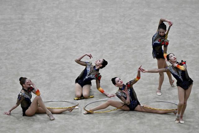 China's team competes in the three hoops and two sets of clubs routine final of the 2026 Rhythmic Gymnastics World Challenge Cup in Beijing on June 21, 2026. (Photo by Pedro PARDO / AFP)