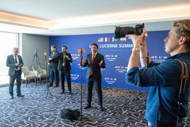 Reporters work during a quadrilateral meeting between the United States, Iran, Pakistan and Qatar at the Burgenstock luxury hotel complex near Lake Lucerne, Switzerland, on June 21, 2026, as part of talks aimed at advancing a deal to end the Middle East conflict. A new round of negotiations over the Middle East war was set to kick off on June 21, 2026 with Iranian negotiators arriving in the Swiss host city hours ahead of US Vice President JD Vance, even as Tehran said it was closing the Strait of Hormuz again over Israeli attacks in Lebanon. (Photo by URS FLUEELER / POOL / AFP)