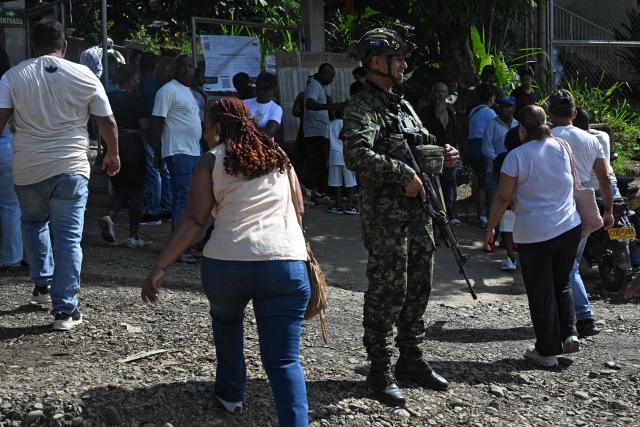 A soldier stands guard outside a polling station during the presidential election runoff, in Santander de Quilichao, Cauca, Colombia, on June 21, 2026. Colombians head to the polls to pick a new president between a hard-right White House-backed lawyer and a leftist senator that will decide the fate of the country's stumbling peace process and strained ties with Washington. (Photo by Joaquin SARMIENTO / AFP)