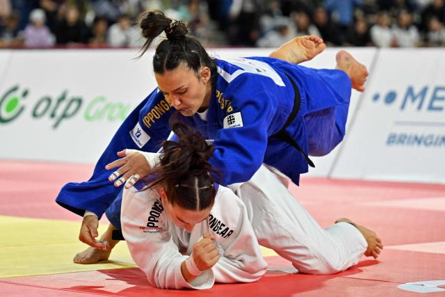 Alina Boehm of Germany (top) competes against compatriot Anna Monta Olek in the women’s under 78kg category for bronze medals at the Judo Ulaanbaatar Grand Slam 2026 in Ulaanbaatar on June 21, 2026. (Photo by ADEK BERRY / AFP)