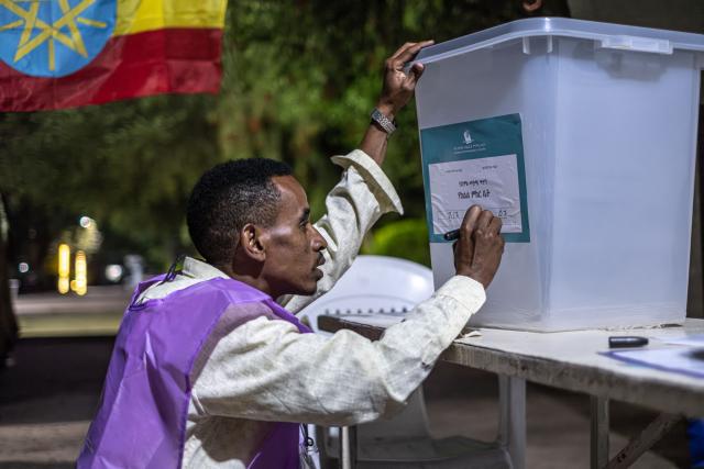 (FILES) A National Election Board of Ethiopia (NEBE) official prepares voting materials ahead of the start of voting in Addis Ababa, on June 1, 2026, during the 2026 Ethiopian parliamentary elections. Ethiopian Prime Minister Abiy Ahmed's Prosperity Party (PP) won a landslide victory in legislative polls held June 1, the election commission said Sunday, giving it almost 90 percent of the seats.
Abiy has led Ethiopia since 2018, and is increasingly criticised for growing authoritarianism, in contrast to his early years when he won the Nobel Peace Prize for mending relations with neighbouring Eritrea.
The PP was considered the overwhelming favourite in the country of 130 million, facing a divided opposition that did not field candidates in many constituencies. (Photo by Marco Simoncelli / AFP)
