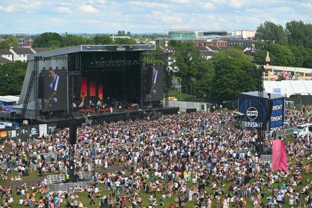 Festivalgoers watch Northern Irish rock band Two Door Cinema Club perform on the main stage during the TRNSMT Festival on Glasgow Green in the centre of Glasgow, Scotland on June 21, 2026, the final day of the three-day festival. (Photo by ANDY BUCHANAN / AFP)