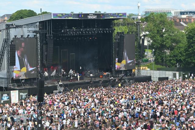 Festivalgoers watch Northern Irish rock band Two Door Cinema Club perform on the main stage during the TRNSMT Festival on Glasgow Green in the centre of Glasgow, Scotland on June 21, 2026, the final day of the three-day festival. (Photo by ANDY BUCHANAN / AFP)