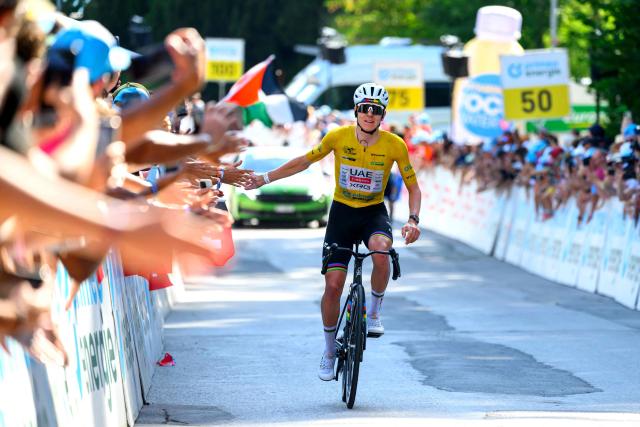 UAE Team Emirates - XRG team's Slovenian rider Tadej Pogacar celebrates as he crosses the finish line to win the fith and final stage of the Men's Tour of Switzerland (Tour de Suisse) cycling race, 150.7 km starting and finishing in Villars-sur-Ollon on June 21, 2026. (Photo by Harold Cunningham / AFP)