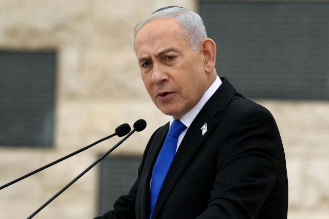 (FILES) Israel’s Prime Minister Benjamin Netanyahu speaks during a ceremony commemorating Israel’s Remembrance Day for fallen soldiers, or Yom HaZikaron, at the Military Cemetery on Mount Herzl in Jerusalem on April 21, 2026. Israeli Prime Minister Benjamin Netanyahu said on June 21, 2026, that Israeli forces would remain in southern Lebanon "as long as necessary", while also vowing to prevent Iran from acquiring nuclear weapons. (Photo by Ilia YEFIMOVICH / POOL / AFP)