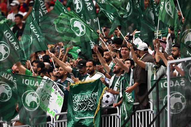 Saudi Arabia supporters wave flags during the 2026 World Cup Group H football match between Spain and Saudi Arabia at the Atlanta Stadium in Atlanta on June 21, 2026.  (Photo by ROBERTO SCHMIDT / AFP)