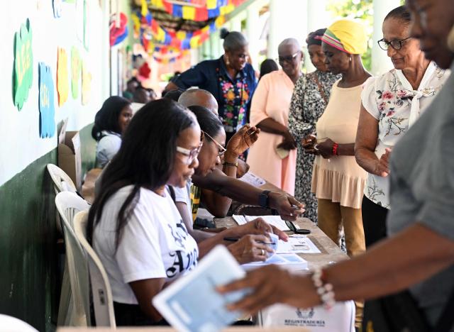 Women vote during the presidential election runoff in Robles, Valle del Cauca, Colombia, on June 21, 2026. Colombians head to the polls to pick a new president between a hard-right White House-backed lawyer and a leftist senator that will decide the fate of the country's stumbling peace process and strained ties with Washington. (Photo by Joaquin SARMIENTO / AFP)