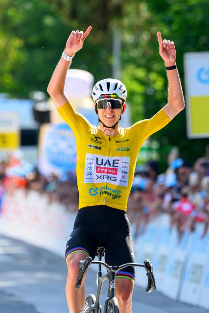 UAE Team Emirates - XRG team's Slovenian rider Tadej Pogacar celebrates as he crosses the finish line to win the fith and final stage of the Men's Tour of Switzerland (Tour de Suisse) cycling race, 150.7 km starting and finishing in Villars-sur-Ollon on June 21, 2026. (Photo by Harold Cunningham / AFP)