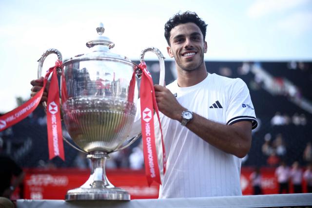 Argentina's Francisco Cerundolo poses for photographers with the winners trophy after his victory over US player Tommy Paul during the men's singles final tennis match on day six of the ATP HSBC Championships at Queen's Club in west London on June 21, 2026. (Photo by Henry NICHOLLS / AFP)